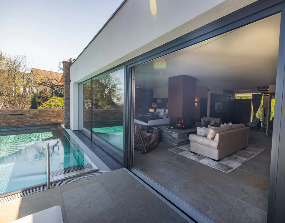 Frameless sliding glazing to a contemporary lounge, design inspiration for garden rooms in Newcastle Frameless sliding glazing opening to a contemporary garden lounge, a North East design idea